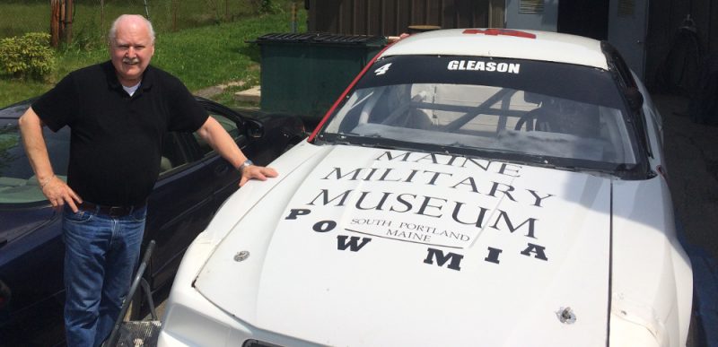 Curator Lee Humiston with the race car.