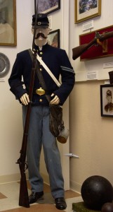 Civil War Corporal with the 9th Maine Volunteer Infantry Regiment. One of only two reproduction uniforms in the museum. The re-enactors uniform is accurate down to the buttons. The weapons are authentic.