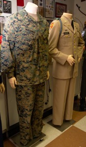 Current combat fatigues for Lance Corporal Sean Montgomery, USMC, currently serving in combat in Afghanistan. On the right are the summer service tans for Captain Jim Mcdonough, US Army, killed in Action in Vietnam on his second tour.