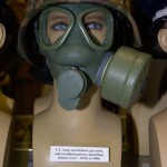 US Army steel helmet, gas mask, and woodland pattern camouflage helmet cover from the 1970s to 1980s.