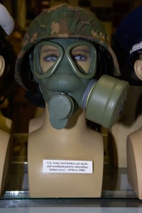 US Army steel helmet, gas mask, and woodland pattern camouflage helmet cover from the 1970s to 1980s.