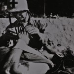 Coast Guard Corpsman giving aid at Normandy.
