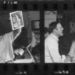 Joe Crecca on plane coming home holding up magazine