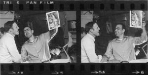 Joe Crecca on plane coming home holding up magazine